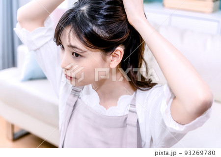 髪をまとめる若い女性 髪をまとめる若い女性 93269780