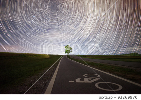 Lonely tree under the beautiful star trails in the starry night. Lonely tree under the beautiful star trails in the starry night. 93269970
