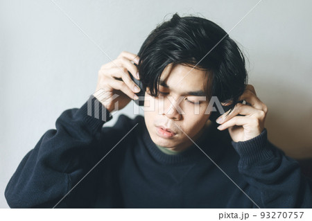 Headshot portrait of young adult asian men with black short hair using headphone listen music Headshot portrait of young adult asian men with black short hair using headphone listen music 93270757
