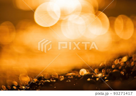Abstract nature summer ocean sunset sea background. Small waves on water surface in motion blur with bokeh lights from sunrise. Holiday, vacation and recreational background concept. Abstract nature summer ocean sunset sea background. Small waves on water surface in motion blur with bokeh lights from sunrise. Holiday, vacation and recreational background concept. 93271417