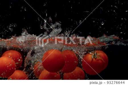 Tomatoes falling into the water 93276644