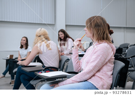 During a college lecture on mathematics, students go about their business, smile and get distracted During a college lecture on mathematics, students go about their business, smile and get distracted 93278631