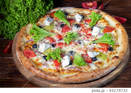 Pizza with bacon and cheese, herbs and cherry tomatoes. With mozzarella, shrimp and octopus, mussels and other products on a wooden background. 93279735