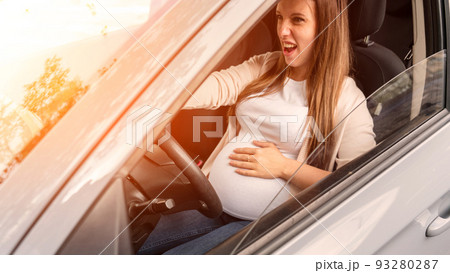 Pregnancy driving car. Young beautiful pregnant woman driving car. Safety pregnancy, mother health care concept. 93280287