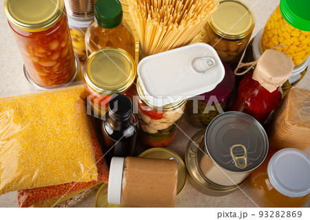 Emergency survival food set on white kitchen table high angle view 93282869