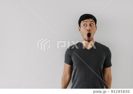 Funny amazing shocked surprised asian man face advertise isolated on white. Funny amazing shocked surprised asian man face advertise isolated on white. 93285830