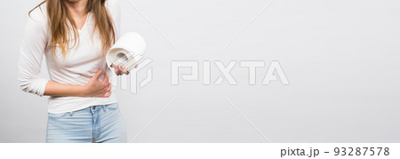 Banner woman with stomach pain and toilet paper roll on white background copy space Banner woman with stomach pain and toilet paper roll on white background copy space 93287578