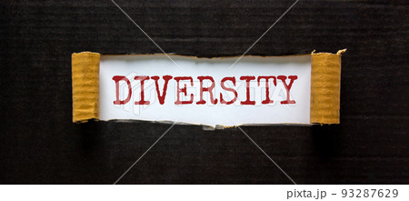 Diversity and inclusion symbol. The word 'Diversity' appearing behind torn black paper. Beautiful black background. Business, inclusion and diversity concept. Copy space. 93287629