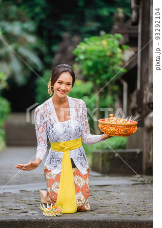 balinese woman in kebaya do prayer and make an offering to go 93292104