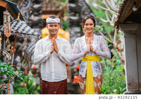 happy balinese couple greeting and smiling gesture at camera 93292135