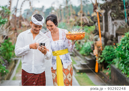 portrait of balinese couple using mobile phone 93292248