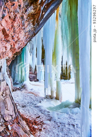 Vertical of tall icicles from rock wall Vertical of tall icicles from rock wall 93296297