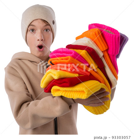 A teenager with surprise, opening his mouth, in a brown sports jacket, holds a lot of knitted hats, isolate A teenager with surprise, opening his mouth, in a brown sports jacket, holds a lot of knitted hats, isolate 93303057