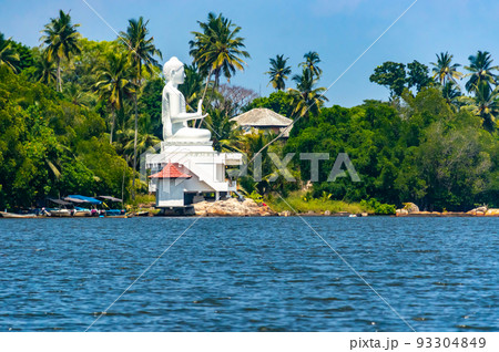 Buddha statue on the bank of the river on the island of Sri Lanka. 93304849