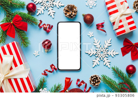 Digital phone mock up with rustic Christmas decorations for app presentation top view with empty space for you design. Christmas online shopping concept. Tablet with copy space on colored background Digital phone mock up with rustic Christmas decorations for app presentation top view with empty space for you design. Christmas online shopping concept. Tablet with copy space on colored background 93305806
