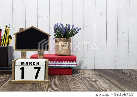 March 17 calendar date text on white wooden block with on wooden desk. March 17 calendar date text on white wooden block with on wooden desk. 93306419
