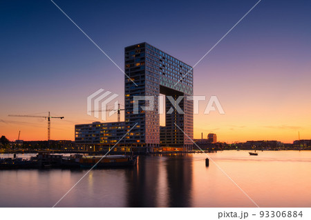 Amsterdam, Netherlands. A cityscape in the evening. A skyscraper and business center. Amsterdam, Netherlands. A cityscape in the evening. A skyscraper and business center. 93306884