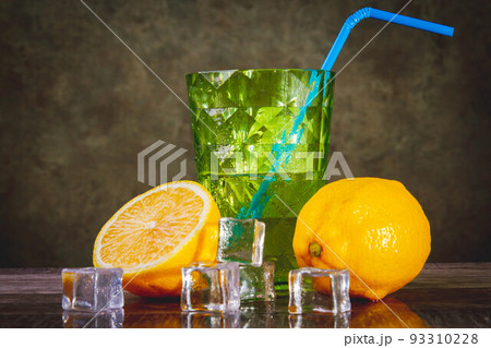 A glass of ice-cold lemon juice. Fruit juice with ice. Lemon slices and ice. 93310228