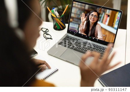 Online Lesson. Unrecognizable woman having video call on laptop with female tutor 93311147
