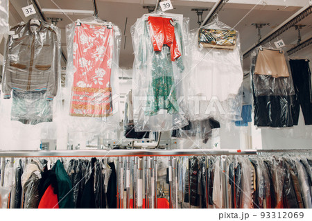 Dry cleaning clothes. Clean cloth chemical process. Laundry industrial dry-cleaning hanging clothes on rack 93312069
