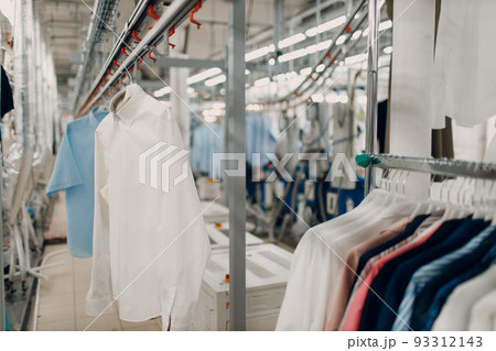 Dry cleaning clothes. Clean cloth chemical process. Laundry industrial dry-cleaning hanging clothes on rack 93312143
