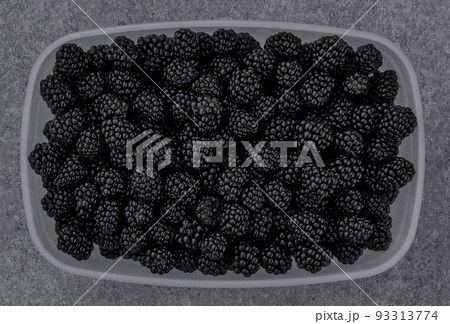 Ripe blackberries in a plastic container top view. Ripe blackberries in a plastic container top view. 93313774