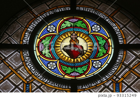 Sacred Heart of Jesus, stained glass window in the parish church of St. Peter and Paul in Oberstaufen, Germany 93315249