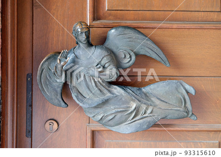 Angel on the door of the Saint Lawrence church in Kleinostheim, Germany Angel on the door of the Saint Lawrence church in Kleinostheim, Germany 93315610