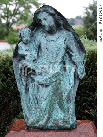 Virgin Mary with baby Jesus, cemetery in Ursberg, Germany 93315617