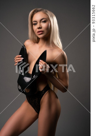 young woman in underwear and black rabbit mask cover breast look at you 93315662