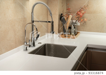 Minimalist kitchen with white countertop and sink Minimalist kitchen with white countertop and sink 93316874