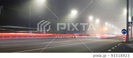 View empty dark night blue foggy misty rainy highway city road backlight red traces low poor visibility cold spring autumn season. Seasonal bad rainy weather accident danger warning car fog light View empty dark night blue foggy misty rainy highway city road backlight red traces low poor visibility cold spring autumn season. Seasonal bad rainy weather accident danger warning car fog light 93318923