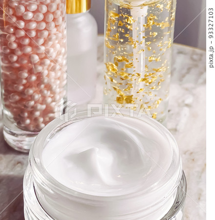 Skincare cosmetics, face cream moisturiser jar, golden serum emulsion bottles, beauty product close-up 93327103