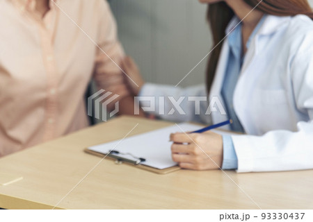 Close up hands Woman doctor holding hands patient encourage cheer up consultation at hospital medicare clinic. Doctor talking to patient support giving hope mental health therapy consoling recovery Close up hands Woman doctor holding hands patient encourage cheer up consultation at hospital medicare clinic. Doctor talking to patient support giving hope mental health therapy consoling recovery 93330437
