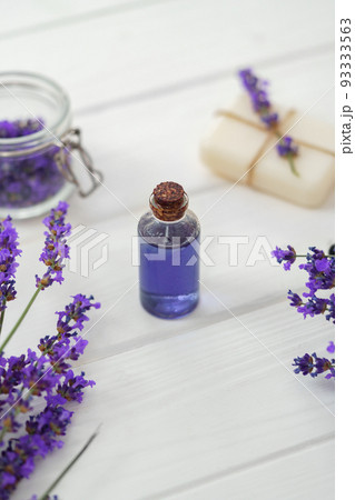 Lavender soap bars and spa products with lavender flowers on a white wooden table 93333563