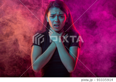Environmental pollution. Scared young man with stressed emotions isolated over pink background with clouds of smoke. Concept of emotions, ecology, problems Environmental pollution. Scared young man with stressed emotions isolated over pink background with clouds of smoke. Concept of emotions, ecology, problems 93335914