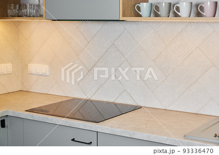 Kitchen interior with induction hob and wooden cabinets, Modern kitchen appliance 93336470