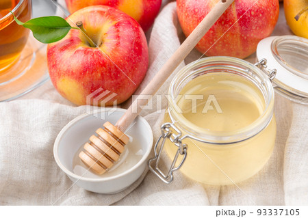 Jewish holiday Rosh Hashanah background with honey and apples on wooden table. Jewish holiday Rosh Hashanah background with honey and apples on wooden table. 93337105