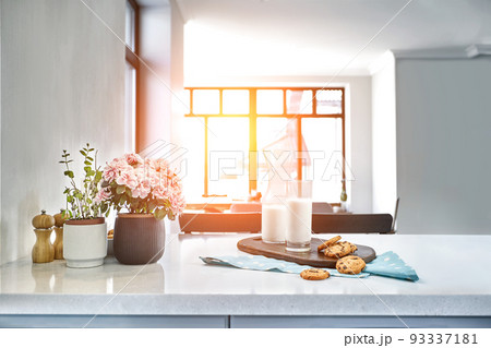 Cookies and Milk with an glass milk bottle on a kitchen counter for a after school snack of cookies and milk Cookies and Milk with an glass milk bottle on a kitchen counter for a after school snack of cookies and milk 93337181