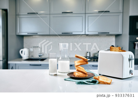 Served table for breakfast with toast, milk and honey, on blurred background 93337631