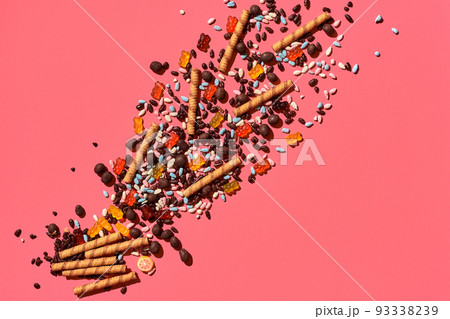 A heap of delicious sweets explode from the corner of image to the top, view from above. From left to the right direction A heap of delicious sweets explode from the corner of image to the top, view from above. From left to the right direction 93338239