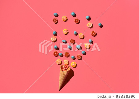 A variety of delicious sweets explode from the waffle cone, view from above. From left to the right direction 93338290