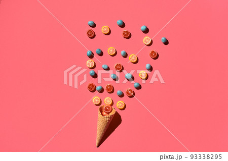 A variety of delicious sweets explode from the waffle cone, view from above. From left to the right direction 93338295