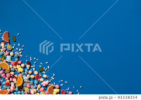 Photo of candies dragee placed on the corner of image with a copy space in the middle 93338354