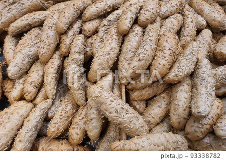 Freshly baked wholegrain Czech rohlik rolls with sunflower seeds in a bakery or grocery store. Fresh bread 93338782