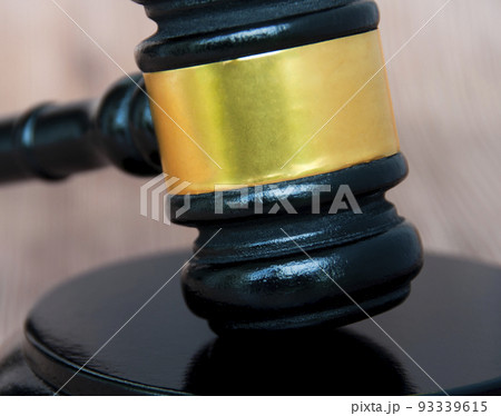 Close up of gavel on wooden table. Copy space and law concept 93339615