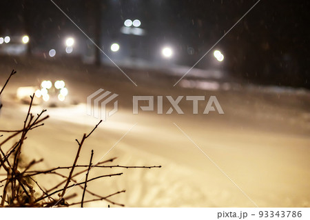 Snowcat removes snow from the night ski slope. Blurred image Snowcat removes snow from the night ski slope. Blurred image 93343786