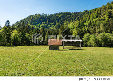 Old Wooden Barn and Hay Rack on a Green Meadow - Alps Slovenia 93344656