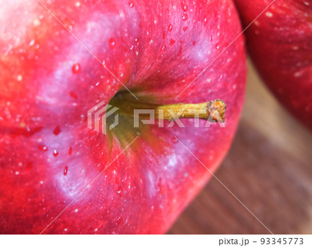 Big ripe red apple, closeup shot. Drops of water on an apple peel. Big ripe red apple, closeup shot. Drops of water on an apple peel. 93345773