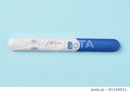 Blue positive pregnancy test on blue background. Positive result of pregnancy test. Blue positive pregnancy test on blue background. Positive result of pregnancy test. 93348051
